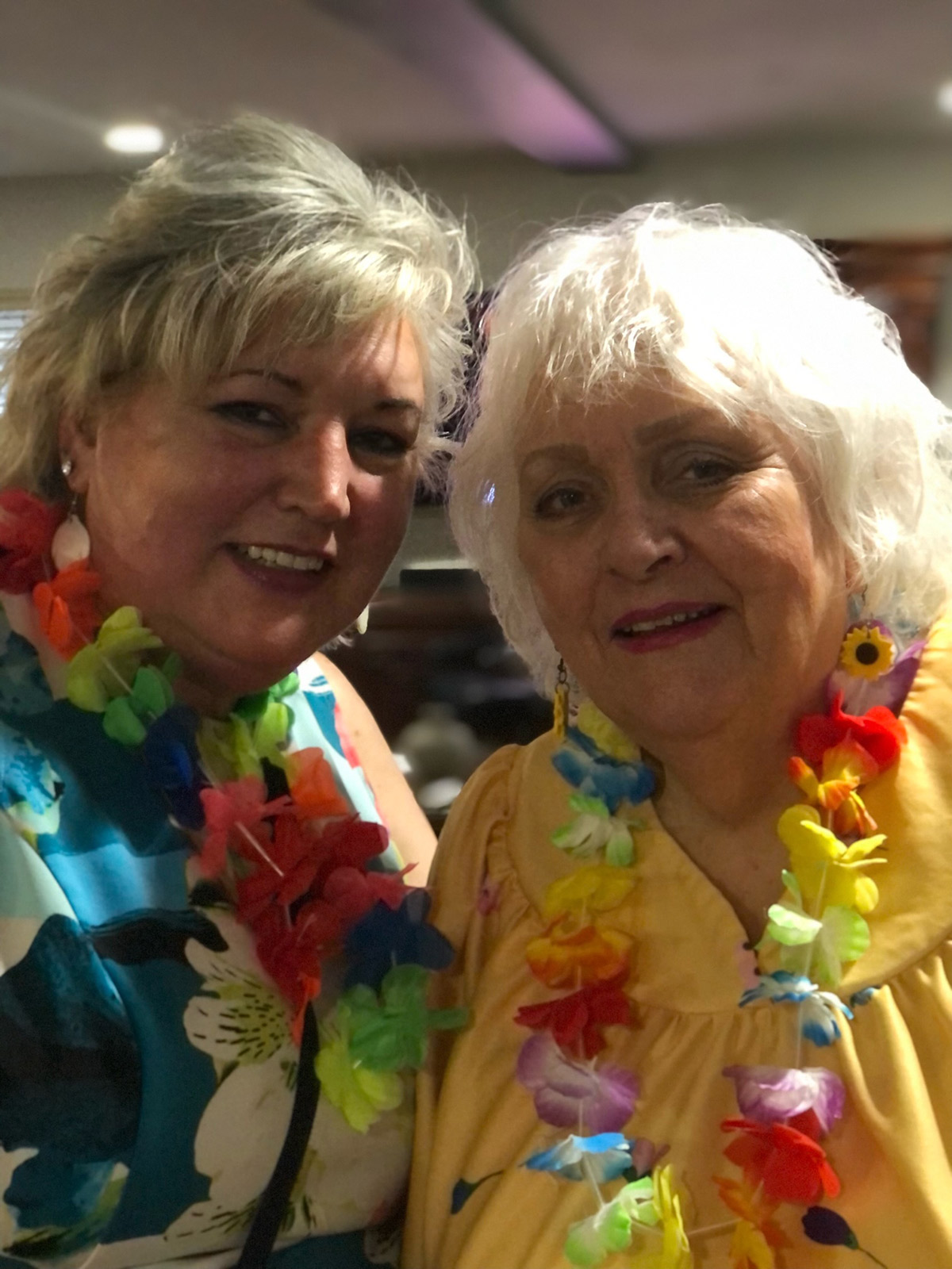 Normandy Park residents smiling, wearing leis